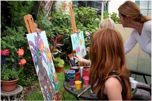 The top 10 art summer camps for kids is a great place for kids to show their art as in this picture of kids painting. 