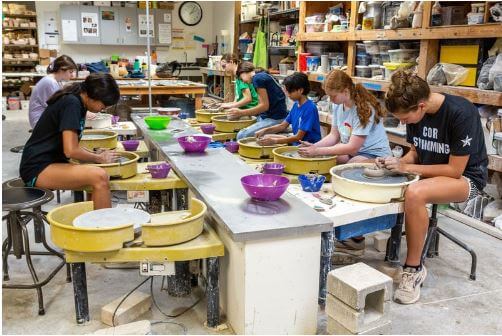 DFW top 10 art summer camps for kids can be creative as this picture of pottery art making class. 