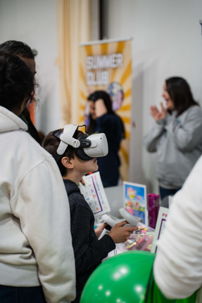 Your Guide to virtual summer camps using online options a picture of a boy with virtual glasses on