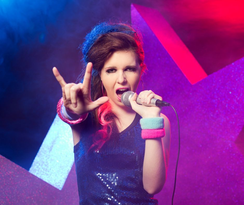 Young girl singing and performering as a rock star at camp.