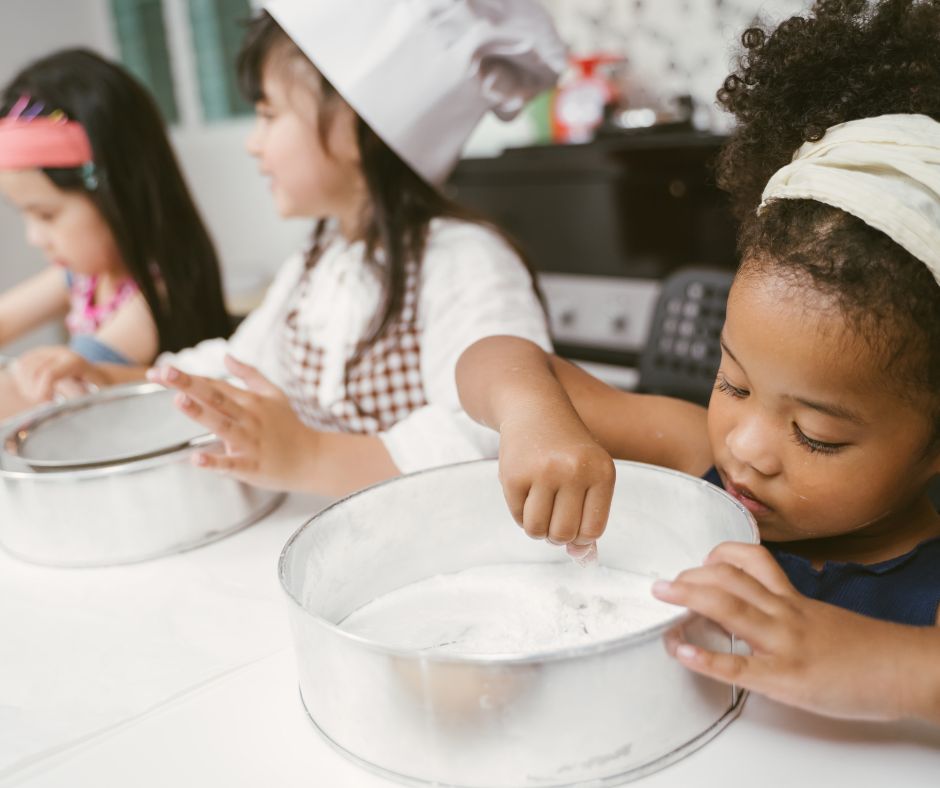 Children cook and prepare dough together.