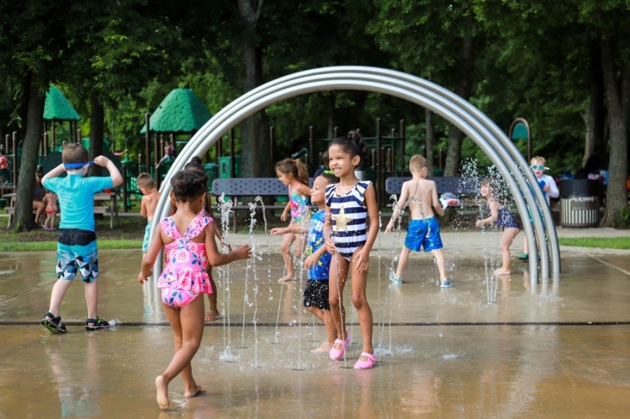 Splash pad in mckinney texas. Kids playing under the water sprayers