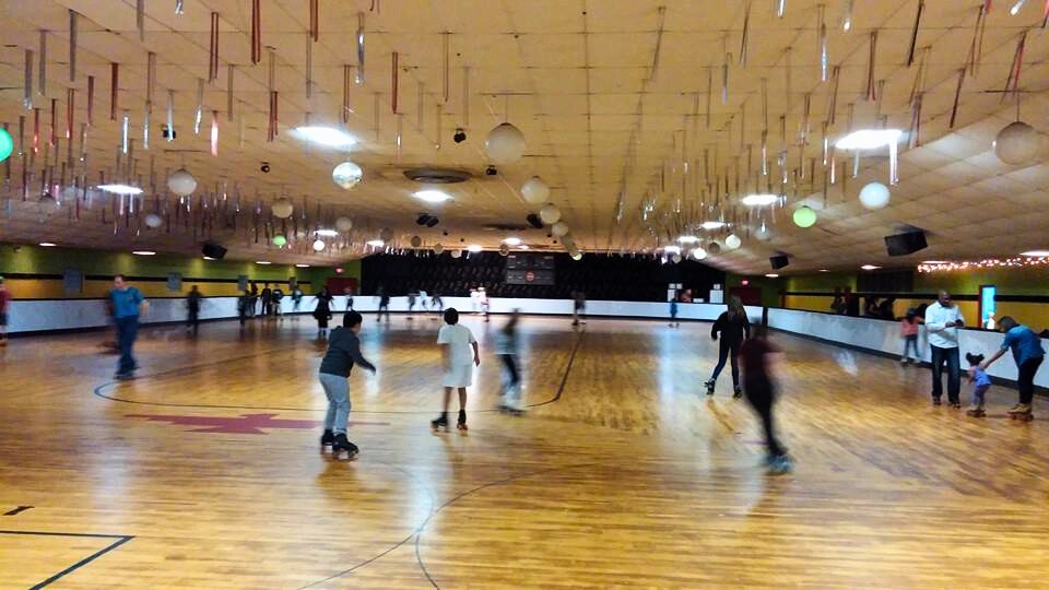 A lively roller skating scene in a large room, perfect for families seeking evening activities in Dallas at Thunderbird Roller Rink.