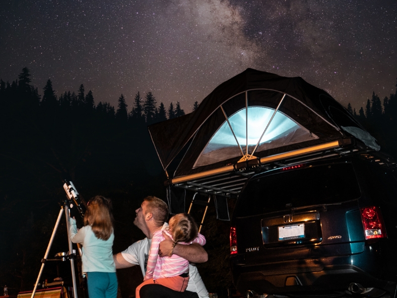 A family enjoys stargazing with a telescope, discovering the beauty of the night sky in Dallas.